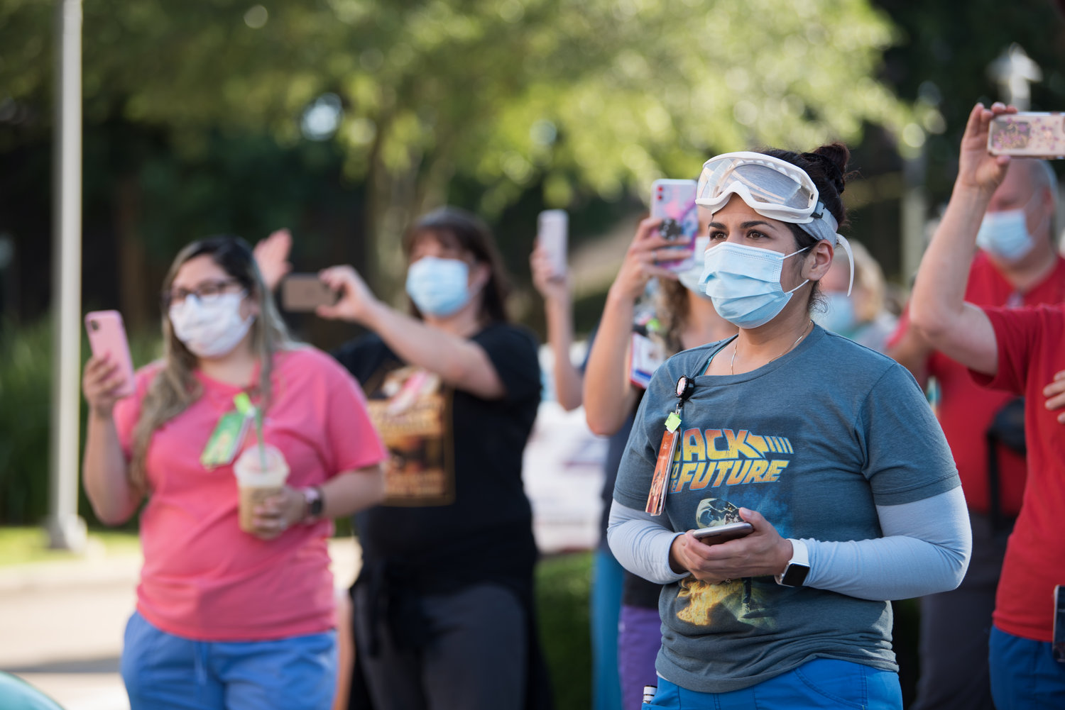 Health care workers stood outside the hospital and waved at first responders going by while wearing masks and keeping safe hygiene practices.